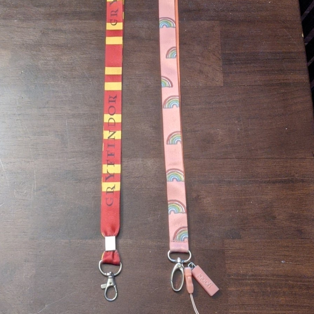 Two lanyards, rainbow Yoobi and Gryffindor